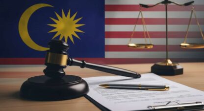 A symbolic image of a gavel, a Malaysian flag element, and a performance review document, representing the intersection of law and HR practices in Malaysia.